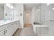 Modern bathroom with double sink vanity, glass shower, and tile floors at 2479 Pine Preserve Ct, St Cloud, FL 34771