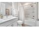 A well-lit bathroom featuring a vanity with a modern sink and a shower-tub with white tile surround at 2479 Pine Preserve Ct, St Cloud, FL 34771