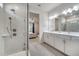 Modern bathroom with dual sink vanity, step-in shower, and a view into the primary bedroom at 2479 Pine Preserve Ct, St Cloud, FL 34771