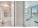 An open doorway shows a bedroom with light blue walls, a white bed frame and an ensuite bathroom at 2479 Pine Preserve Ct, St Cloud, FL 34771