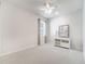 Bright, neutral bedroom featuring carpet floors, a window and a white media console with a table lamp at 2479 Pine Preserve Ct, St Cloud, FL 34771