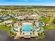 Aerial shot of the community center with tennis courts, a resort-style pool, and ample parking at 2479 Pine Preserve Ct, St Cloud, FL 34771