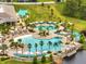 Aerial view of the community pool area, boasting several pools, seating, and shade structures at 2479 Pine Preserve Ct, St Cloud, FL 34771