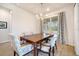 Well-lit dining room features a stylish chandelier, modern curtains, and comfortable seating for six at 2479 Pine Preserve Ct, St Cloud, FL 34771