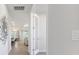 Inviting hallway featuring wood-look floors and modern decor that lead into the dining and living areas at 2479 Pine Preserve Ct, St Cloud, FL 34771