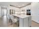 Modern kitchen with stainless steel appliances, a center island with bar seating, and sleek white cabinetry at 2479 Pine Preserve Ct, St Cloud, FL 34771