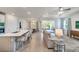 Open concept living room with view of the dining area, kitchen, and covered patio at 2479 Pine Preserve Ct, St Cloud, FL 34771