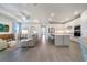 Open-concept living room and kitchen features a tray ceiling, recessed lighting, and modern finishes at 2479 Pine Preserve Ct, St Cloud, FL 34771