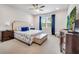 Serene main bedroom with large windows, plush bedding, and elegant furnishings at 2479 Pine Preserve Ct, St Cloud, FL 34771