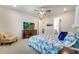 Bright main bedroom featuring a king bed, nightstands, and a large dresser at 2479 Pine Preserve Ct, St Cloud, FL 34771