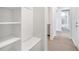 Hallway view of mud room with built-in storage and a view of the bathroom at 2479 Pine Preserve Ct, St Cloud, FL 34771