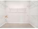 Empty walk-in closet featuring carpeted floors and white wire shelving on all sides for maximum storage at 2479 Pine Preserve Ct, St Cloud, FL 34771