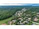An aerial view showcases a quiet neighborhood surrounded by dense trees, close to community amenities at 267 Osprey Hammock Trl, Sanford, FL 32771