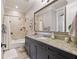Bathroom featuring dark cabinets, granite countertops, and a shower with a tub at 267 Osprey Hammock Trl, Sanford, FL 32771