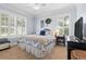 This bedroom features carpet floors, many windows with shutters, and a queen-sized bed at 267 Osprey Hammock Trl, Sanford, FL 32771