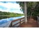 Relaxing deck view overlooking a serene body of water with lush trees and greenery surrounding the seating area at 267 Osprey Hammock Trl, Sanford, FL 32771
