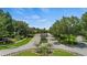 Elegant gated community entrance with lush landscaping and decorative stone features at 267 Osprey Hammock Trl, Sanford, FL 32771