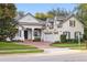 Charming home exterior features a brick driveway, lush landscaping, and classic architectural design at 267 Osprey Hammock Trl, Sanford, FL 32771