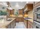 Kitchen with granite counters, stainless steel appliances, and custom wood cabinets at 267 Osprey Hammock Trl, Sanford, FL 32771