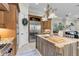Spacious kitchen featuring custom cabinets, stainless steel appliances, granite countertops, and an island at 267 Osprey Hammock Trl, Sanford, FL 32771