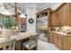 Spacious kitchen with wood cabinetry, granite island, stainless steel refrigerator, and eat-in area at 267 Osprey Hammock Trl, Sanford, FL 32771