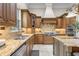 Elegant kitchen showcasing wood cabinetry, granite countertops, stainless appliances, and a tiled backsplash at 267 Osprey Hammock Trl, Sanford, FL 32771