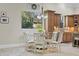 Bright eat-in kitchen with modern cabinets, glass table, and pendant lighting at 267 Osprey Hammock Trl, Sanford, FL 32771