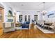 Spacious living room with hardwood floors and a dining table with chandelier at 267 Osprey Hammock Trl, Sanford, FL 32771