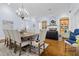 This living room has hardwood floors, a dining table, and an arched fireplace at 267 Osprey Hammock Trl, Sanford, FL 32771