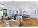 Spacious living room with hard wood floors, neutral paint, and a connected dining room at 267 Osprey Hammock Trl, Sanford, FL 32771