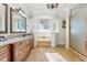 Bright bathroom with jacuzzi tub, glass shower, granite counters, and column details at 267 Osprey Hammock Trl, Sanford, FL 32771