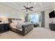 Main bedroom featuring large windows, neutral paint, and tray ceilings at 267 Osprey Hammock Trl, Sanford, FL 32771