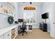 Stylish office features built-in storage, a large window, and a comfortable workspace setup at 267 Osprey Hammock Trl, Sanford, FL 32771