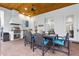 Outdoor kitchen and dining area with stainless steel grill, granite countertop, and seating for six at 267 Osprey Hammock Trl, Sanford, FL 32771