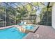 Screened in pool and spa with lounge chairs to enjoy the outdoor space at 267 Osprey Hammock Trl, Sanford, FL 32771