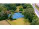 Overhead view of community tennis courts surrounded by lush greenery and well-maintained grounds at 267 Osprey Hammock Trl, Sanford, FL 32771