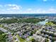 Expansive aerial shot showcasing a community with mature trees, serene lakes, and meticulously planned residential streets at 2729 Stanwood Dr, Kissimmee, FL 34743