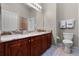 Bathroom with double sinks, granite countertops, tile floors, and a large mirror at 2729 Stanwood Dr, Kissimmee, FL 34743
