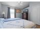 Bedroom with two beds, wood floors, ceiling fan, and a large dresser with a flat screen television at 2729 Stanwood Dr, Kissimmee, FL 34743