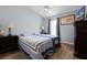 Bedroom with two beds, wood floors, ceiling fan, and a large dresser with a flat screen television at 2729 Stanwood Dr, Kissimmee, FL 34743