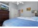 Bedroom with two beds, wood floors, ceiling fan, and a large dresser with a flat screen television at 2729 Stanwood Dr, Kissimmee, FL 34743