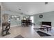 Open-concept dining area with tile floors, neutral wall paint, and stylish furniture at 2729 Stanwood Dr, Kissimmee, FL 34743