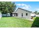 Exterior of the home features a screened-in porch and well-maintained lawn at 2729 Stanwood Dr, Kissimmee, FL 34743