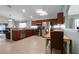 Modern kitchen with stainless steel appliances, wood cabinets, and granite countertops at 2729 Stanwood Dr, Kissimmee, FL 34743