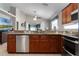 Open kitchen with granite counters, stainless steel appliances, and dark wood cabinetry at 2729 Stanwood Dr, Kissimmee, FL 34743