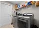 Laundry room with stainless steel washer and dryer, shelving and lots of room for storage at 2729 Stanwood Dr, Kissimmee, FL 34743