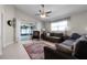 Spacious living room with sliding glass doors to the patio, a ceiling fan, and comfortable seating at 2729 Stanwood Dr, Kissimmee, FL 34743