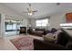 Cozy living room with vaulted ceiling, ceiling fan, tile floors and sliding glass doors to the patio at 2729 Stanwood Dr, Kissimmee, FL 34743