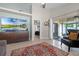 Open living room offering a tile floor, large screen TV, sliding glass door access to the screened lanai at 2729 Stanwood Dr, Kissimmee, FL 34743