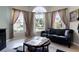 Living room with large windows, a comfortable couch, and a decorative round wooden table at 2729 Stanwood Dr, Kissimmee, FL 34743